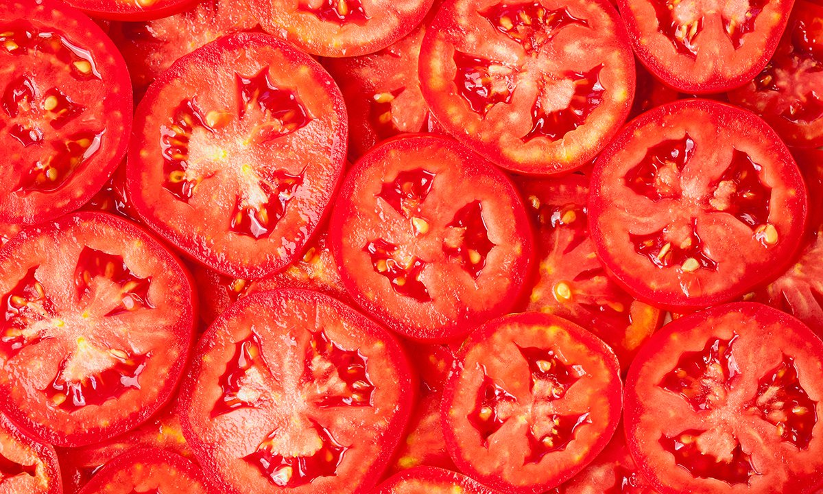 Image of many red tomato slices layred on top of each other