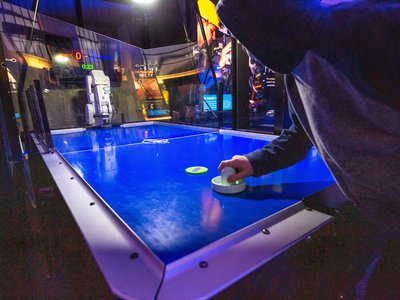 Guest playing the air hockey robot in Speed exhibition.